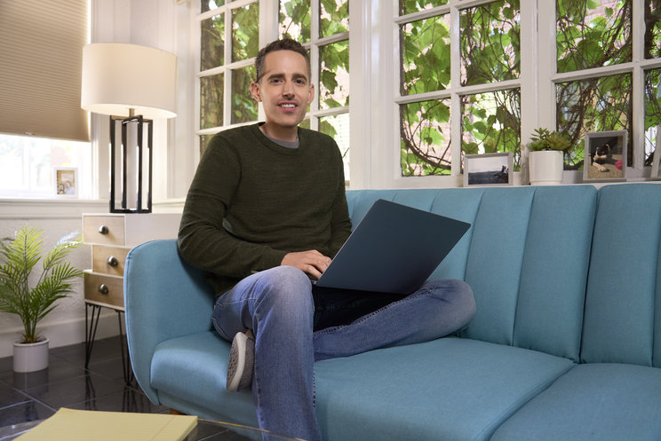 Image of KESIMPTA Crew member Andy using his laptop computer  